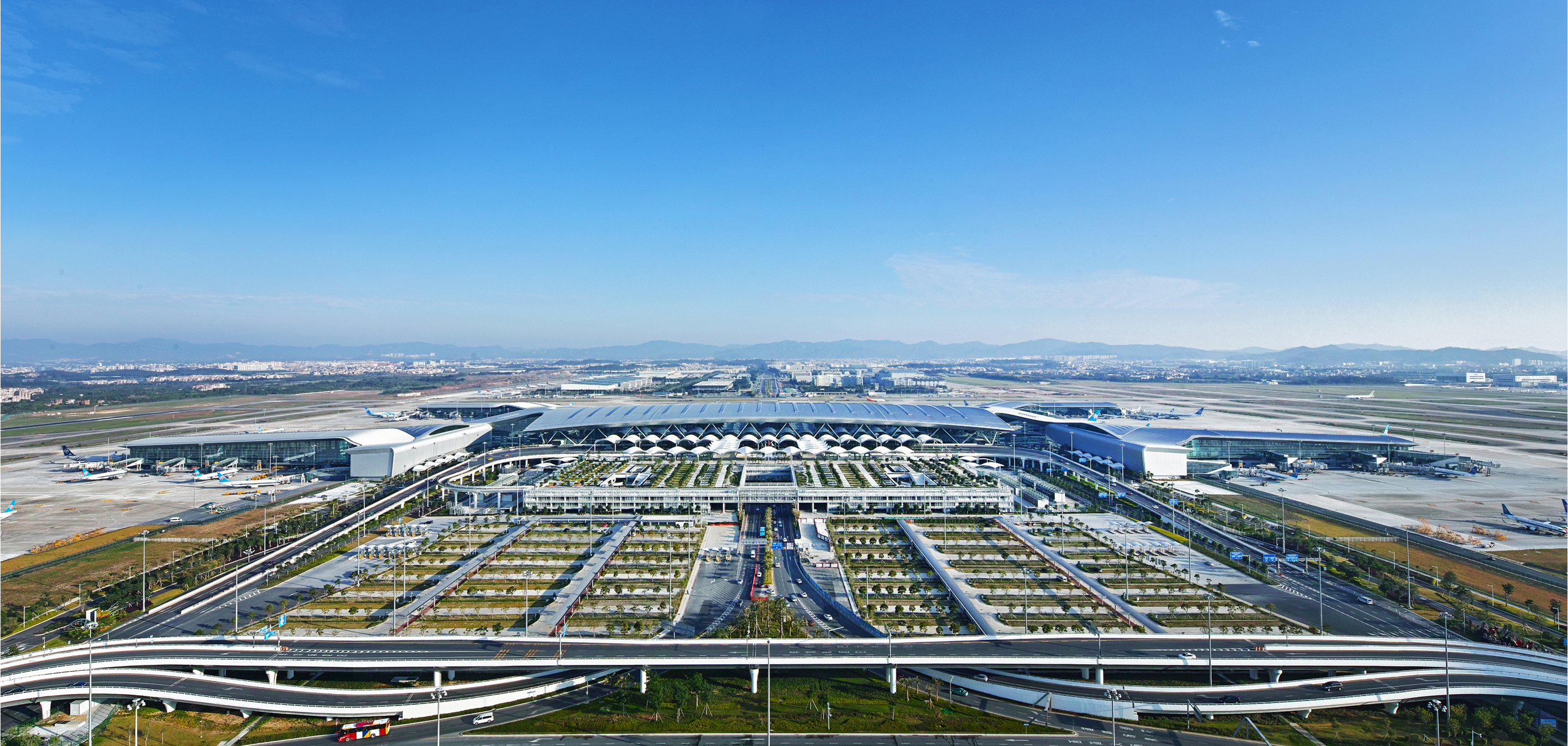 Daytime aerial view of Guangzhou Baiyun International Airport Terminal 2 and its supporting airport facilities.