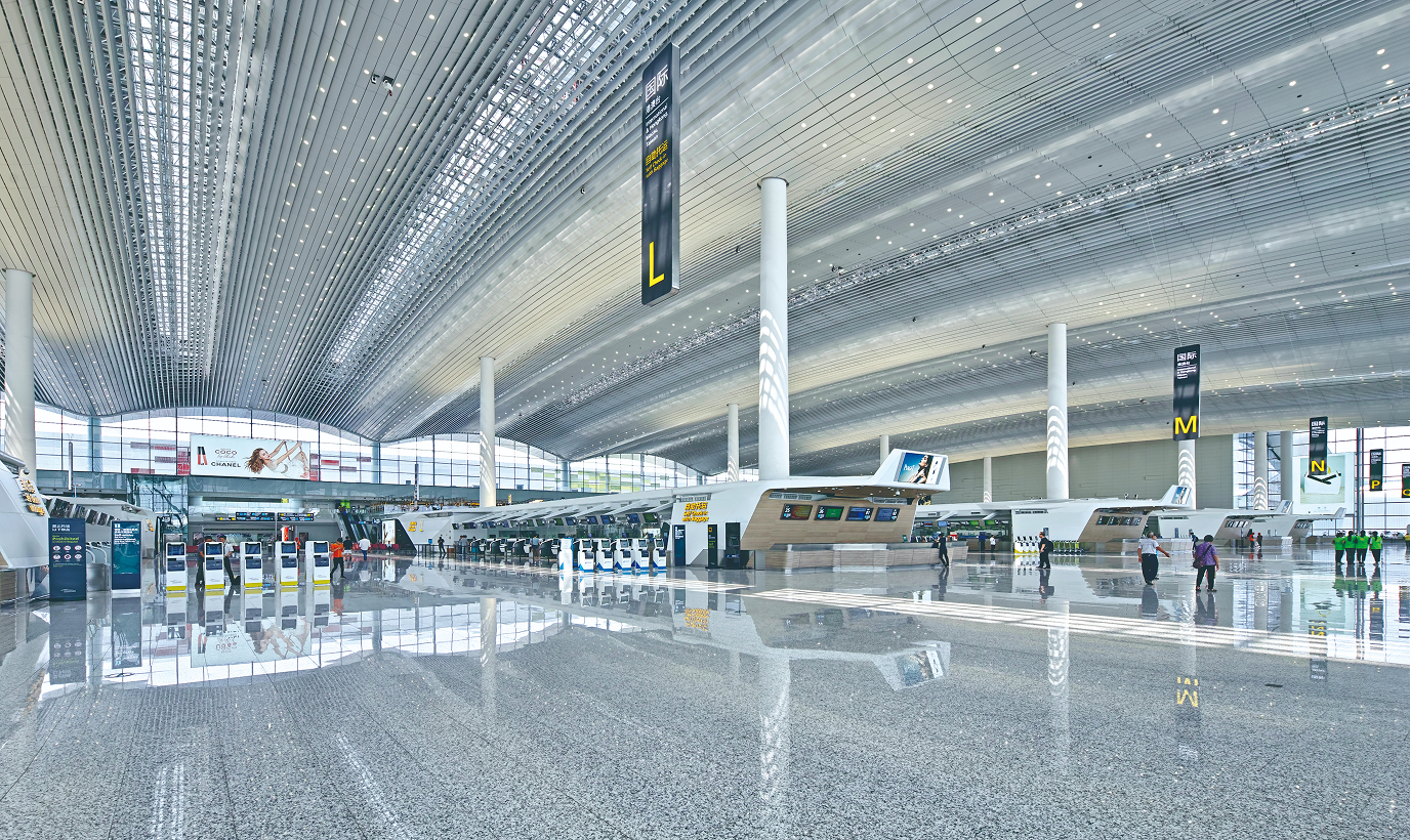 Check-in island inside the airport terminal departure environment.