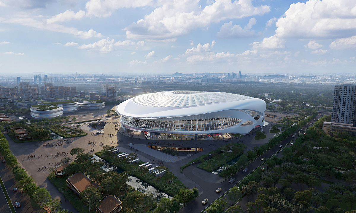 Daytime aerial view of the stadium showing the completed roof form against the surrounding park landscape.