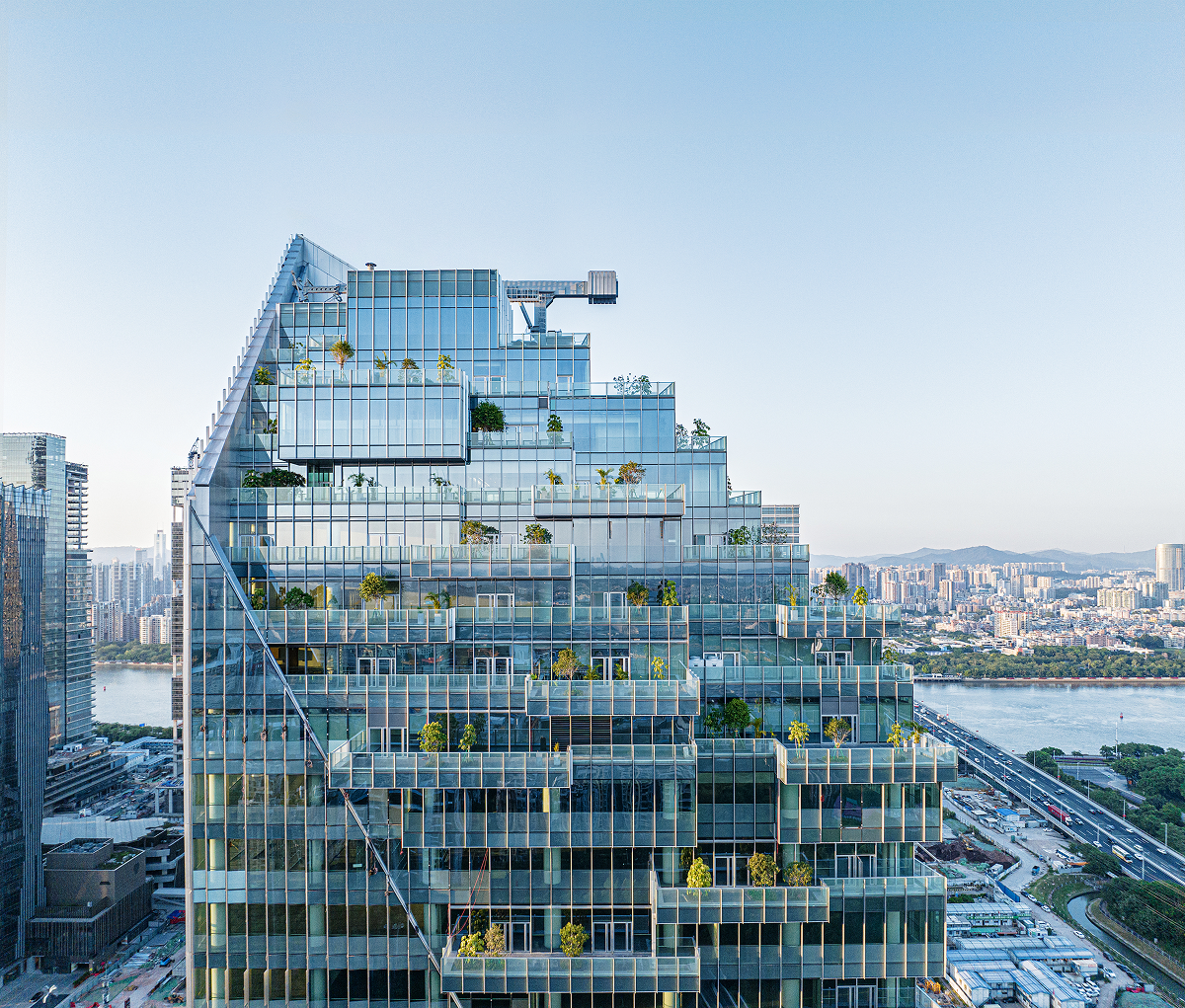 Aerial view showing the cascading sky garden terraces set into the tower's facade.