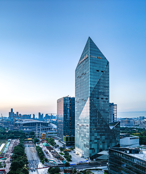 View of the building's north-west corner showing the curtain wall and facade transitions.