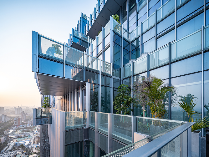 View looking up through a sky garden terrace toward the upper floors of the tower.