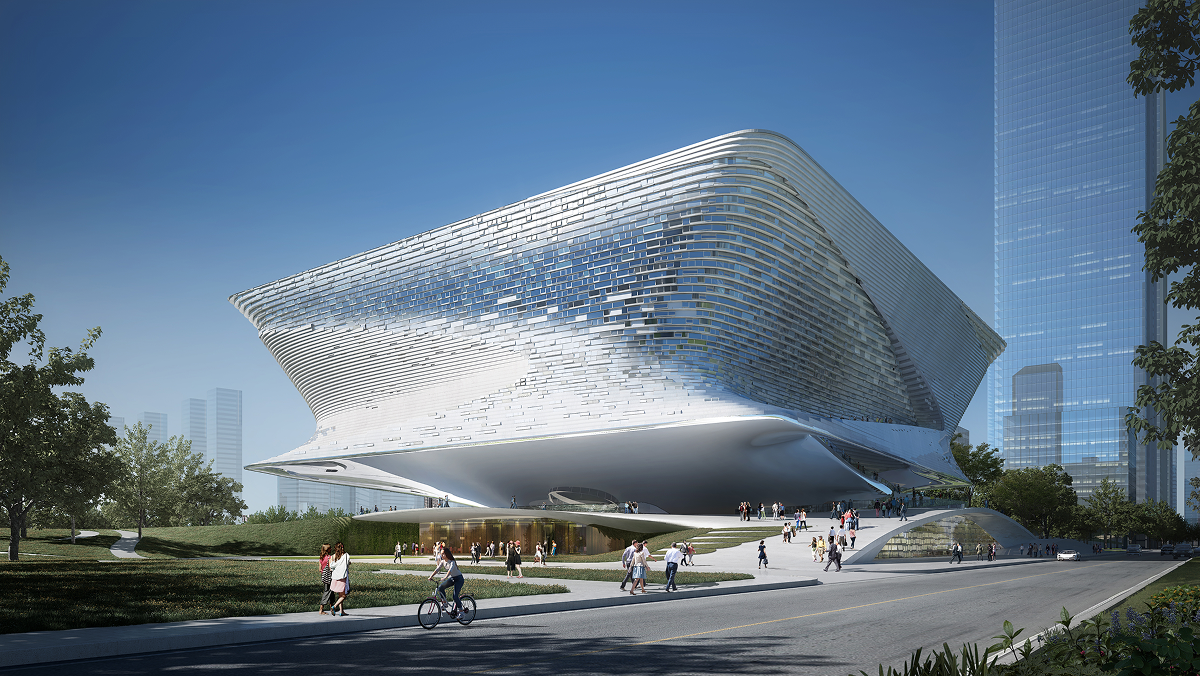 Ground-level view of the exhibition hall's facade with cyclists and pedestrians on the adjoining street.
